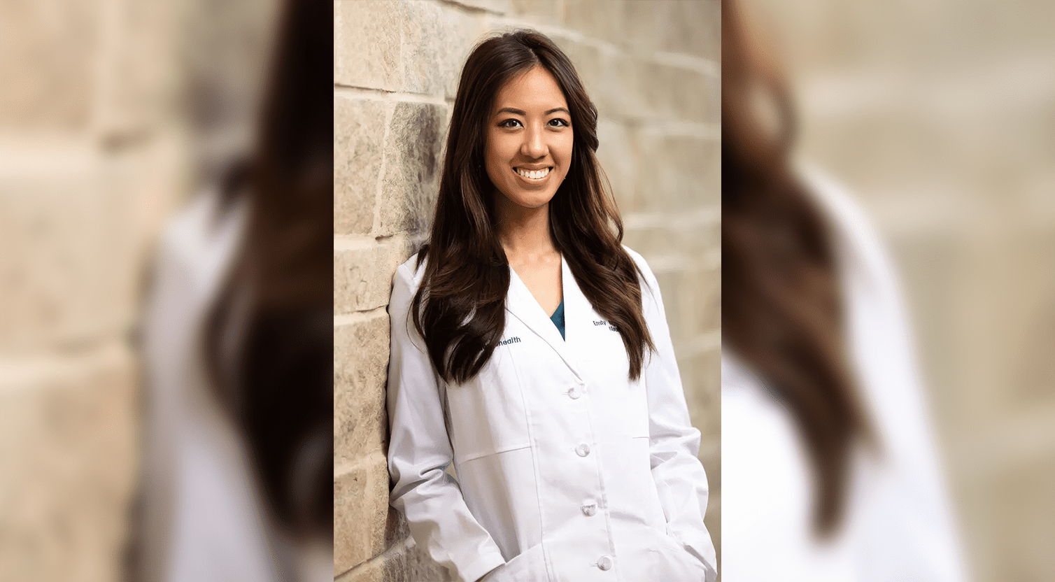 A woman wearing white coat standing